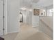 Bright and airy hallway with neutral carpet, showcasing multiple doorways and a decorative mirror to the side at 2170 Buxton Dr., Myrtle Beach, SC 29579