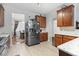 Open concept kitchen features stainless steel refrigerator, wood cabinets and marble countertops at 2170 Buxton Dr., Myrtle Beach, SC 29579