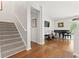 View of staircase leading to living room, with shiny hardwood floors and black piano and seating at 2170 Buxton Dr., Myrtle Beach, SC 29579