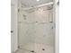 Modern glass-enclosed shower featuring stone-tiled walls and rainfall showerhead at 2170 Buxton Dr., Myrtle Beach, SC 29579