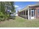 Spacious backyard featuring a screened-in porch and ample green space perfect for outdoor activities and relaxation at 2302 Clandon Dr., Myrtle Beach, SC 29579