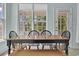 Charming dining area with a wooden table, chairs, and natural light from large windows at 2302 Clandon Dr., Myrtle Beach, SC 29579