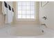 A soaking tub below a window offers a relaxing respite from the day at 2506 Berleze Ct., Conway, SC 29527