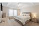 Bright bedroom boasts tray ceiling, ceiling fan, and ensuite bathroom at 2506 Berleze Ct., Conway, SC 29527