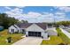 The exterior of this one-story home features a large driveway and a screened-in garage at 2506 Berleze Ct., Conway, SC 29527
