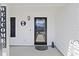 Inviting front porch with a black front door, welcome mat, and decorative accents at 2506 Berleze Ct., Conway, SC 29527