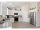 Well-lit kitchen featuring white cabinets, granite countertops, and stainless steel appliances at 2506 Berleze Ct., Conway, SC 29527