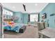 Bright bedroom featuring colorful bedding, hammock chair, and flat screen television at 260 Palmetto Harbour Dr., North Myrtle Beach, SC 29582