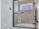 Modern shower with black hardware and a glass enclosure, featuring a bright window at 260 Palmetto Harbour Dr., North Myrtle Beach, SC 29582