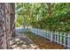 Side yard features a well-manicured lawn bordered by a white picket fence and mature trees at 2701 Hillside Dr. S # 1, North Myrtle Beach, SC 29582