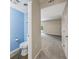 Half bathroom showing a blue accent wall, and modern toilet with wood-style flooring at 2701 Hillside Dr. S # 1, North Myrtle Beach, SC 29582