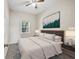 Staged bedroom featuring a tan bed, ceiling fan, and landscape artwork at 2701 Hillside Dr. S # 1, North Myrtle Beach, SC 29582