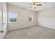 Bedroom with neutral walls, carpeted floor, a ceiling fan, and natural light from two windows at 2701 Hillside Dr. S # 1, North Myrtle Beach, SC 29582