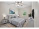 Staged bedroom featuring a grey bed, a ceiling fan, and landscape artwork at 2701 Hillside Dr. S # 1, North Myrtle Beach, SC 29582
