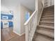 Open entryway with stairs, carpet, and access to a kitchen with bright blue cabinets at 2701 Hillside Dr. S # 1, North Myrtle Beach, SC 29582