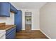 Kitchen featuring blue cabinets, wood counters, and a view into carpeted room at 2701 Hillside Dr. S # 1, North Myrtle Beach, SC 29582