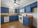 Bright kitchen featuring blue cabinets, wood countertops, and modern appliances at 2701 Hillside Dr. S # 1, North Myrtle Beach, SC 29582
