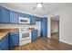 Bright kitchen features blue cabinets, wood countertops, and stainless steel appliances at 2701 Hillside Dr. S # 1, North Myrtle Beach, SC 29582