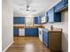 Well-lit kitchen showcasing blue cabinetry, wood countertops, and modern appliances at 2701 Hillside Dr. S # 1, North Myrtle Beach, SC 29582