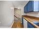 The kitchen has blue cabinets and wood floors, with the stairway visible from the kitchen at 2701 Hillside Dr. S # 1, North Myrtle Beach, SC 29582