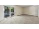 Bright living space with sliding doors to the backyard, neutral paint, and plush carpet at 2701 Hillside Dr. S # 1, North Myrtle Beach, SC 29582