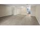 Open-concept living room showcasing neutral paint, plush carpet, and seamless flow to the kitchen at 2701 Hillside Dr. S # 1, North Myrtle Beach, SC 29582