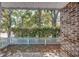 View of the patio from a white picket fence with an abundance of trees behind at 2701 Hillside Dr. S # 1, North Myrtle Beach, SC 29582