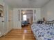 A bedroom with hardwood floors, a doorway to another bedroom, and a bed with blue and white comforter at 2917 Chippenham Rd., Marion, SC 29571