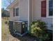 Close-up of a Goodman HVAC unit beside home with red shutters and greenery at 2917 Chippenham Rd., Marion, SC 29571
