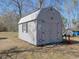 Exterior view of grey storage shed on a large lawn with a metal roof and double doors at 2917 Chippenham Rd., Marion, SC 29571