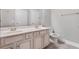 Well-lit bathroom featuring a double vanity with updated faucets and a tile floor and white door at 2993 Moss Bridge Ln., Myrtle Beach, SC 29579