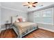 Cozy bedroom featuring hardwood floors, a ceiling fan, and a queen size bed with a patterned comforter at 2993 Moss Bridge Ln., Myrtle Beach, SC 29579