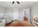 Bright bedroom with hardwood floors, a ceiling fan, neutral paint and carpet, with open doorway at 2993 Moss Bridge Ln., Myrtle Beach, SC 29579