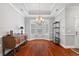 Open dining area boasting a tray ceiling, a bay window, and gleaming hardwood floors at 2993 Moss Bridge Ln., Myrtle Beach, SC 29579