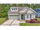 Charming home featuring a manicured lawn, brick-lined driveway, and a welcoming blue front door at 2993 Moss Bridge Ln., Myrtle Beach, SC 29579