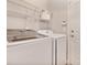 Bright laundry room featuring a modern washer and dryer, with wire shelving for organizing supplies at 2993 Moss Bridge Ln., Myrtle Beach, SC 29579