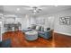 Comfortable living room features hardwood floors, gray sofa, modern decor and access to the kitchen and stairway at 2993 Moss Bridge Ln., Myrtle Beach, SC 29579