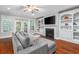 Cozy living room boasts a fireplace, built-in shelving, hardwood floors, and a comfortable sofa at 2993 Moss Bridge Ln., Myrtle Beach, SC 29579