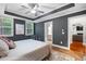 Comfortable main bedroom features a tray ceiling, natural light, and an ensuite bathroom access at 2993 Moss Bridge Ln., Myrtle Beach, SC 29579