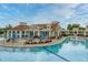 Relaxing pool area with tables, chairs, umbrellas, and manicured landscaping at 2993 Moss Bridge Ln., Myrtle Beach, SC 29579