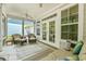 Screened-in porch with ceiling fan, two wicker chairs with ottomans, and views of the yard at 2993 Moss Bridge Ln., Myrtle Beach, SC 29579