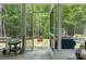 View from screened-in porch to a backyard with grill and wood fire pit at 2993 Moss Bridge Ln., Myrtle Beach, SC 29579