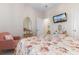 Bedroom with floral quilt, pastel chair, makeup table, and natural light at 315 Cattle Drive Circle, Myrtle Beach, SC 29588
