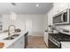 Modern kitchen with an island, stainless appliances, and light wood floors at 315 Cattle Drive Circle, Myrtle Beach, SC 29588