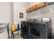 Modern laundry room with sleek, dark gray washer and dryer and a storage shelf at 315 Cattle Drive Circle, Myrtle Beach, SC 29588