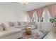 Inviting living room featuring a neutral sofa, area rug and natural light through windows at 315 Cattle Drive Circle, Myrtle Beach, SC 29588