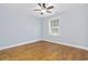 The cozy bedroom features neutral paint, hardwood floors, ceiling fan, and a window with blinds at 3550 Pampas Dr. # 2, Myrtle Beach, SC 29577