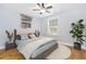 Cozy bedroom features a comfortable bed, a window with blinds, hardwood floors, and a ceiling fan at 3550 Pampas Dr. # 2, Myrtle Beach, SC 29577