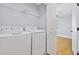 Convenient laundry area with washer, dryer, shelving, and easy access from an adjacent room at 3550 Pampas Dr. # 2, Myrtle Beach, SC 29577