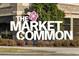 The Market Common sign is surrounded by greenery and flowers at 3550 Pampas Dr. # 2, Myrtle Beach, SC 29577